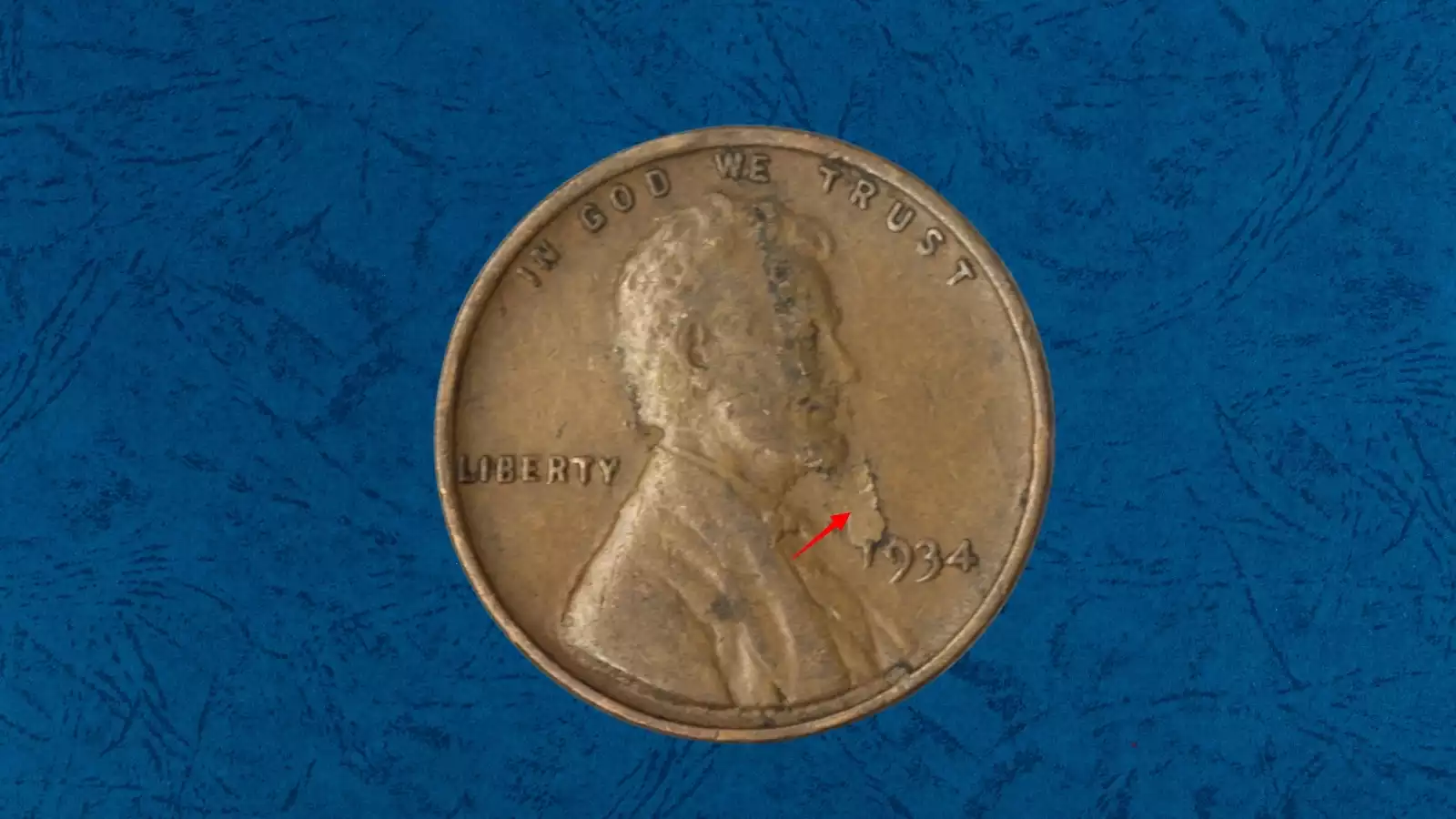 1934 Wheat Penny lamination error showing peeling copper surface layer revealing metal beneath